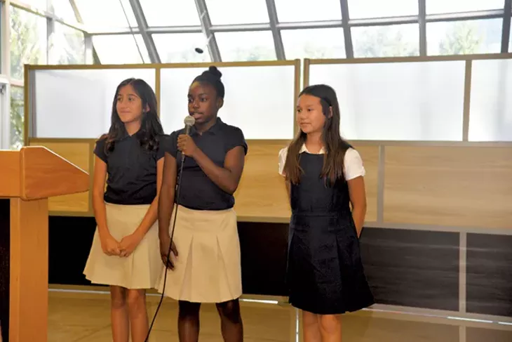 John Rex Charter School sixth-graders from left Adamari Hernandez, Jamya Boyd and Alyssa Penrod delivered the school’s creed to a crowd at the Aug. 2 unveiling of the new middle school’s classroom at Myriad Botanical Gardens. - NAZARENE HARRIS