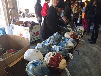 Volunteers prepare turkeys for distribution at Jesus House. - JESUS HOUSE / PROVIDED