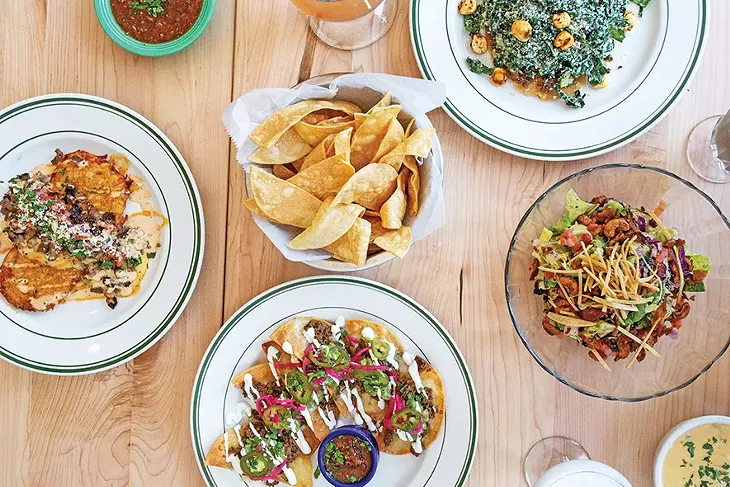 from left Brisket papas, half moon nachos, kale caesar tostada and Mexrad Chop salads - ALEXA ACE