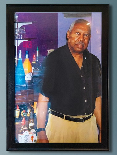 A portrait of Elmer’s Uptown’s founder Elmer Kemp hangs by the entrance. - PHILLIP DANNER