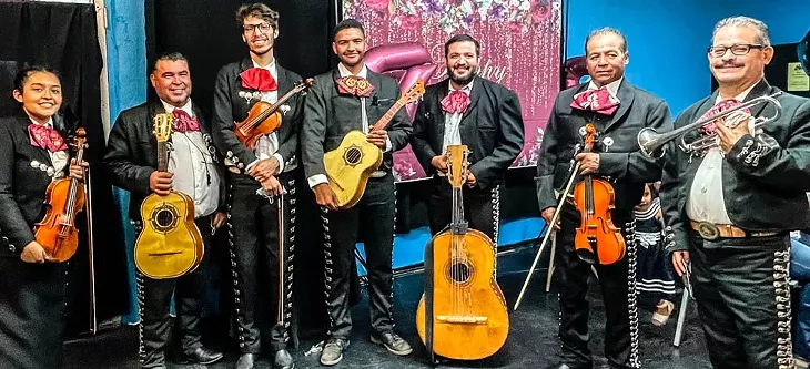 Mariachi Los Viajeros pose after a performance. - KM BRAMLETT