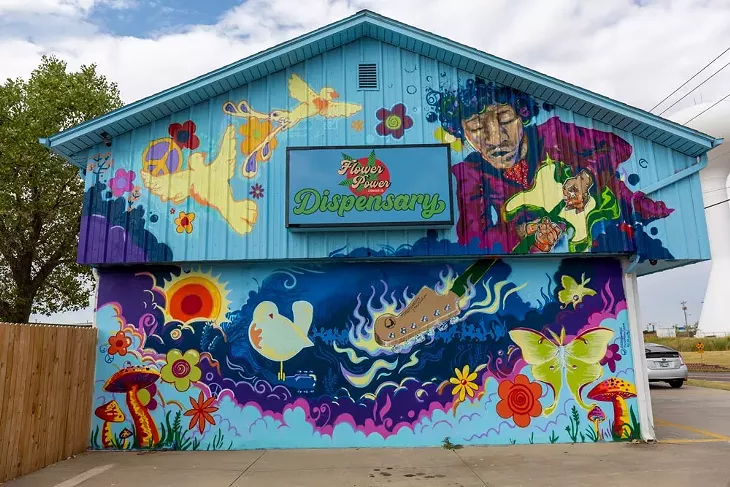 Mural on Flower Power Dispensary by Grant & Kaylyn Stacey @roadrunnermurals - BERLIN GREEN