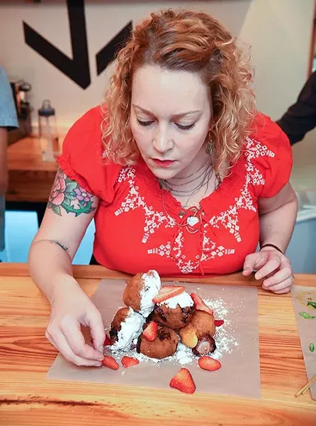 Beth Lyon, the chef at Anchor Down puts together a stack of strawberry fritters for a photo shoot and tasting at the new restaurant. mh