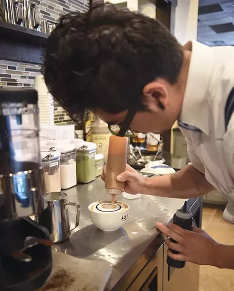 Jeremy Forquer creates a Carmal Macchiato at All About Cha, 13921 N. May Avenue. mh