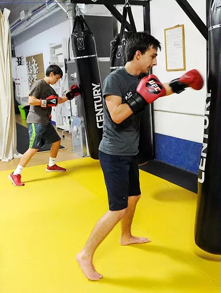 Maxium Lujan, left, and Anton Barykin during a kickboxing class at Conan's Kick Boxing Karate Academy in Norman, Thursday, Jan. 7, 2015. - GARETT FISBECK