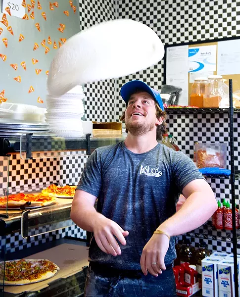 Owner, Drew Mains tosses pizza dough at Knuck's Wheeelhouse (Shannon Cornman)