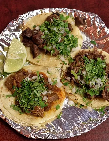 Barbacoa, carnitas and lengua tacos at Taqueria la Tropicana, 12-21-15. - MARK HANCOCK