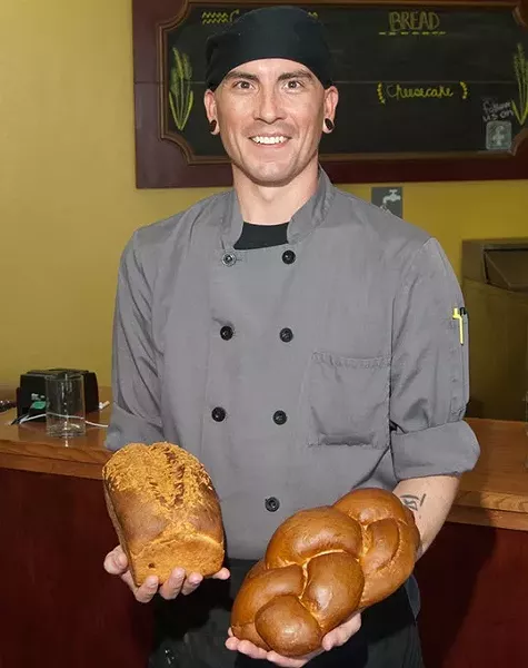Baker John Collins with 4 braid challah and Jalapeno cheddar breads. (Mark Hancock)