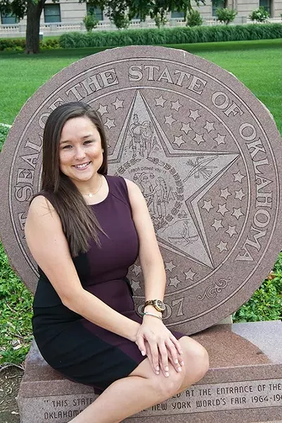 Oklahoma House District 85 candidate Cyndi Munson poses on the State Seal monument in front of the State Capitol. mh