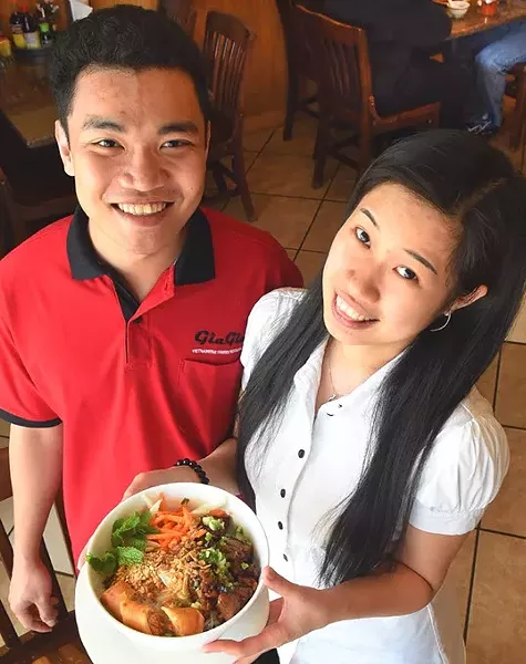 Left, Cuu Le and Thuy Tran with Bun thit nuong cha gio, at Gia Gia Vietnamese Restaurant. mh