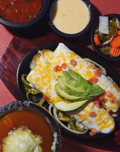 Tacate, sauces and Avocado Enchiladas at Wholly Guacamole Kitchen in Midwest City. mh