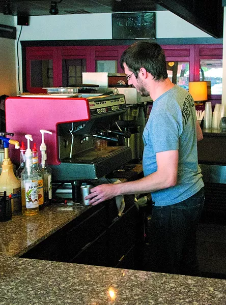 Jason Weigand works behind the counter at District Coffee House. (Mark Hancock)