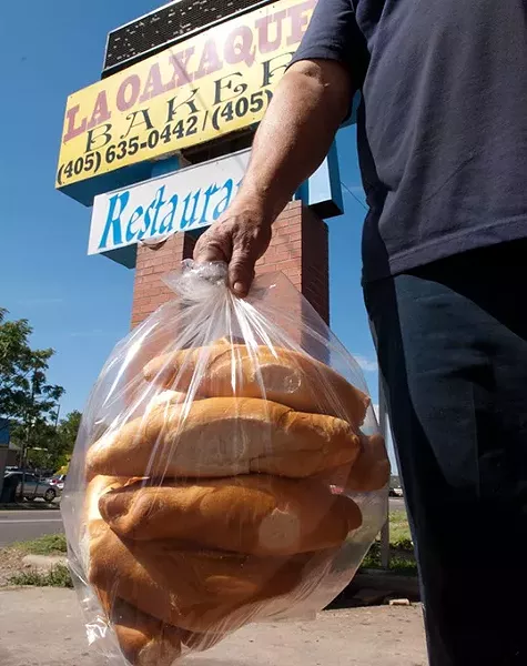 A customer carries out a clear bag full of fresh bread from La Oaxaquena Bakery, 741 SW 29th Street. (Mark Hancock)