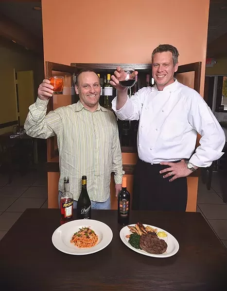 From left, Brian Cure, GM, and Robert DeCoste, Owner and Chef at Patrono, with drinks and two dishes, Bucatini Amatriciana pasta, left, and Steak Frites. The Pinnacoli red wine is suggested by them to be a good pairing for both of these dishes, 11-10-15. - MARK HANCOCK