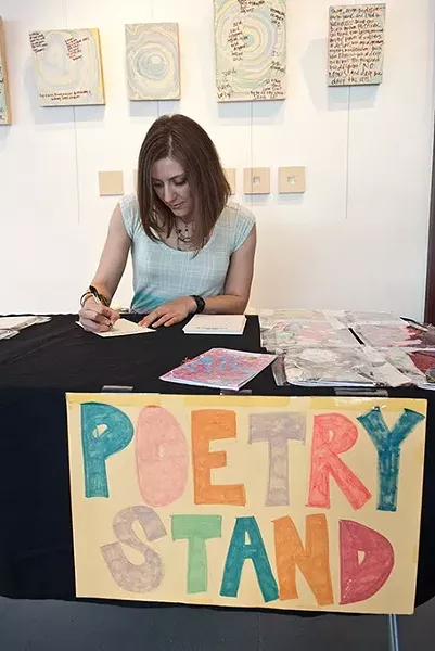 Kerri Shadid, Skirvin Hilton's Artist-in-Residence, writes a poem on the spot for visitors. mh