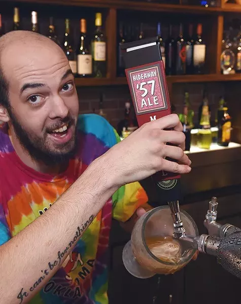 Bartender Brandon Whitehouse pulls a Hideaway 57 Ale, at Hideaway Pizza, 6616 N. Western Avenue in Oklahoma City. - MARK HANCOCK