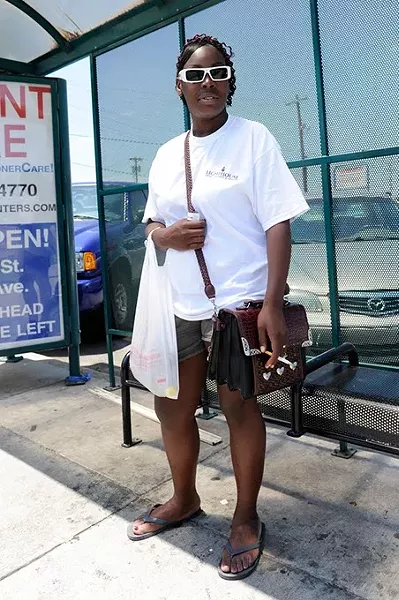 Laquanna Tucker waits for a bus in Oklahoma City, Thursday, June 11, 2015. - GARETT FISBECK