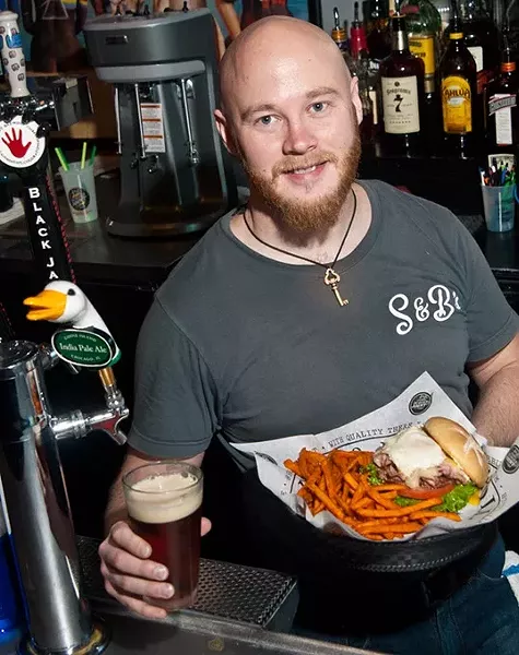 Locke Grant at the bar with the Frankenburger, sweet potatoe fries, and an Octoberfest draft beer, at S&B Burger Joint in Norman. mh