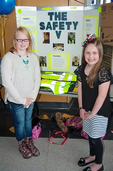 Last year’s winners of the Oklahoma Student Inventors Exposition, Kylie Thompson, left, and Jadyn Waddle, both from Heritage Trails Elementary in Moore, are shown with their project. They created a tornado safety vest featuring a colored strobe light, alert whistle, glow sticks, identification holders and other useful implements which could be worn during severe weather. - KEN BEACHLER