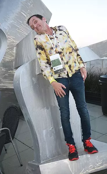 Tyson Meade poses with a sculpture while attending the OKCMOA opening night rooftop party for the DeadCenter Film Festival, 6-11-2015. Mark Hancock