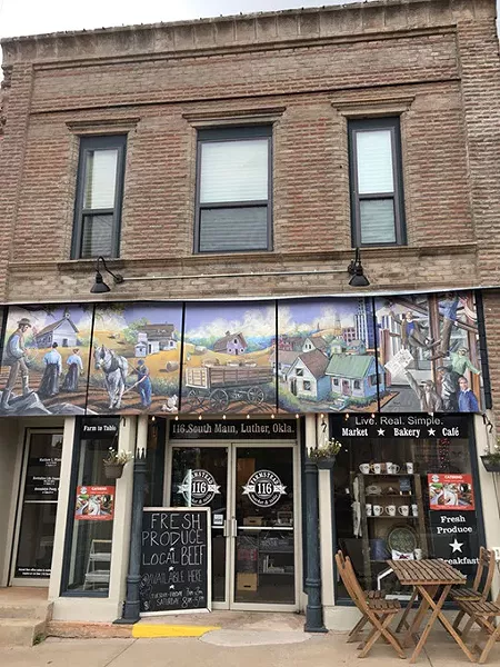 The exterior mural at 116 Farmstead in downtown Luther depicts the town’s history. | Photo Jacob Threadgill