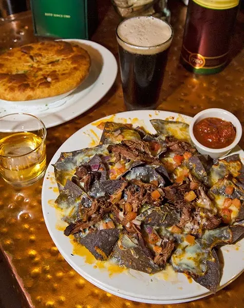 Pot Roast Nachos, up front, with a Chicken Pot Pie, shown with Irish Whiskey and Beer, at Blackbird Gastropub. mh