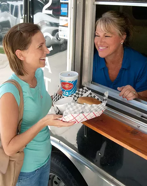 Melanie Wilson gets some lunch from Jan Clem at the window of Klemm's Smoke Haus, on location at Oklahoma Employee's Credid Union, 8-1-14. mh