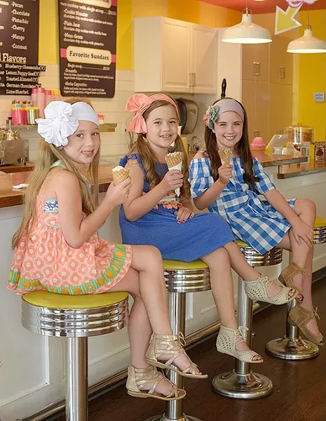 Journey Morgan, 7, Paizley Morgan, 8, and Berkley Burroughs, 7, pose for a photo with their ice cream cones at Roxy's Ice Cream Social, Wednesday, Aug. 2, 2017. - GARETT FISBECK