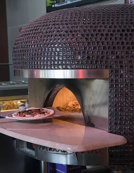 A pizza goes into the custom-built Italian oven at Volare in Norman, Tuesday, Dec. 27, 2016. - GARETT FISBECK