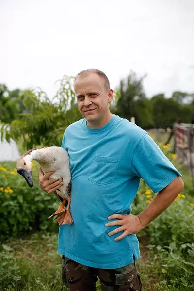 Wes Tibbs holds a goose at his farm in Oklahoma City, Friday, June 24, 2016. "We got into it because it's a marketing angle for when we move beyond the hobby farm level. I think they're a really good organization, in that, they provide people who are doing far bigger things than I am doing an opportunity to get their name out there and get a different angle on marketing that a lot of people don't have.... As consumers are moving toward the locally grown movement, it really gives them a leg up to join the locally grown movement." - GARETT FISBECK