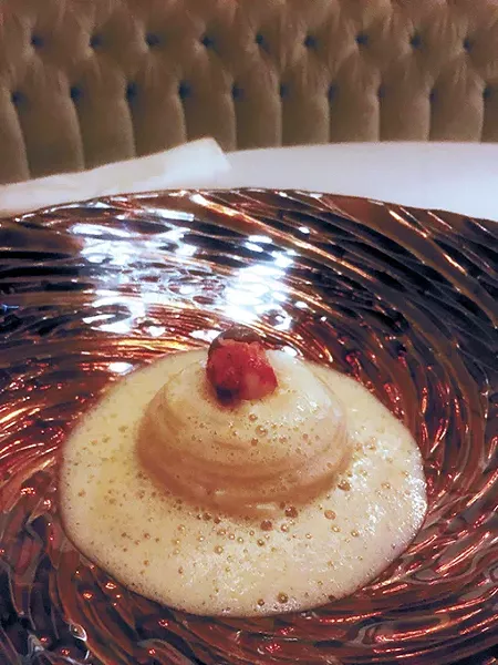 Lobster and mushrooms served inside a - spaghetti roll with scallop mousse, topped - with bisque. - JACOB THREADGILL