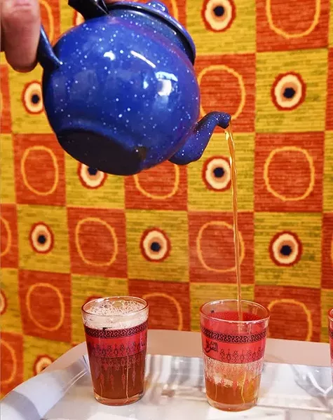 Pouring glasses of Moroccan hot mint tea at Argan Cafe, 2908 NW 23rd Street, OKC, 12-10-15. - MARK HANCOCK