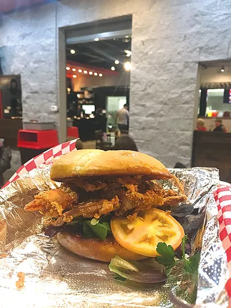 Softshell crab is served whole on a bun with mixed greens, tomato and chipotle aioli. | Photo Jacob Threadgill