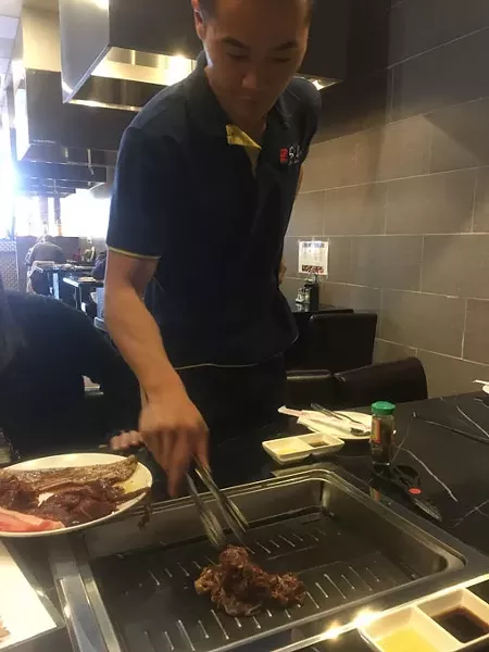 Diners take control of their meal by attending to meat on a sizzling electric grill at Shilla Korean BBQ in Norman. | Photo Jacob Threadgill
