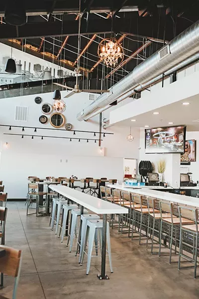 One of two large bars inside the 7,000 square-foot dining room at Industry Gastro Lounge - ALEXA ACE
