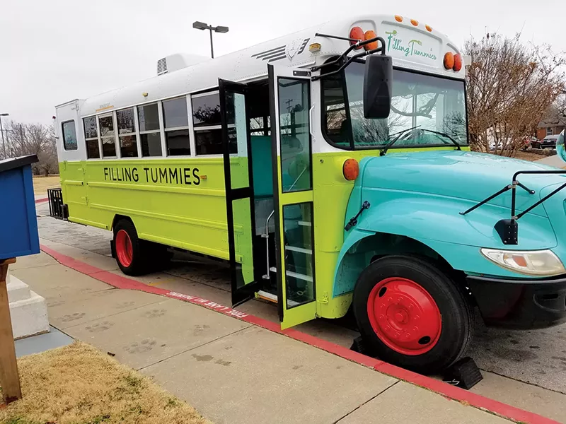 The Filling Tummies mobile food pantry is a brightly colored school bus that travels to schools, low-income apartment complexes, senior centers and afterschool programs offering free, fresh food. - PROVIDED