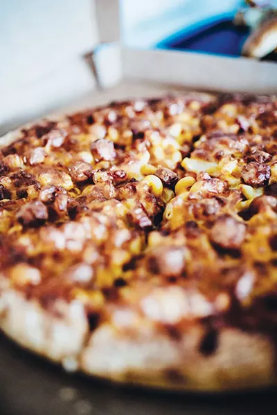 The Pi Pizzeria stand now serves a mac and cheese pizza topped with hot dogs. - ALEXA ACE