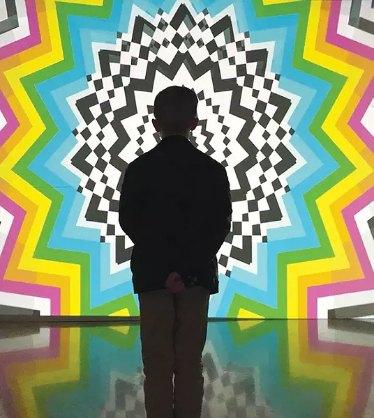 A young visitor is mesmerized by Daniel Sutliff’s video animation in The Experience. - AHHA / PROVIDED