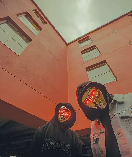 The members of ATLiens keep their identities hidden behind glowing metallic masks. - PROVIDED