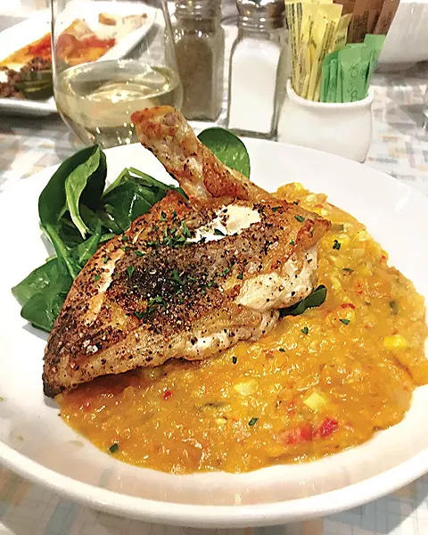 The salt-and-pepper chicken at Aurora with corn purée is on its new dinner menu. - JACOB THREADGILL