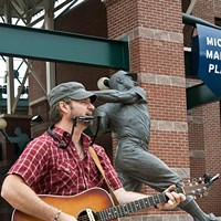 Out of the Box performer, Chad Slagle, plays near the Mickey Mantle statue at the Bricktown Ballpark, 7-19-14.  mh  mh