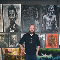 Artist J. Chris Johnson with his art showing at Brass Bell Studios.