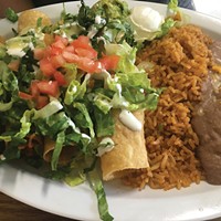 Chicken flautas with sides of rice and beans.