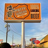 The Patty Wagon sign overlooks the Charcoal Oven location next door.