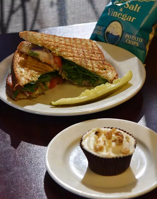Honey Orange Chicken Panini sandwich and chips, with a cupcake for dessert, at The Sweetery Eatery on N. May Avenue in OKC, 11-13-15. - MARK HANCOCK