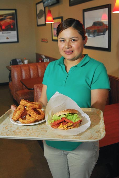 Eva Trejo Acevedo with a tray of goodies, the bacon cheeseburger and onion rings will be featured at Taste of Midwest City, from Judge's Char Grill.  mh