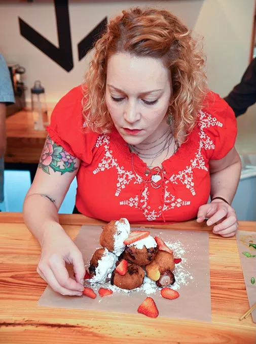 Beth Lyon, the chef at Anchor Down puts together a stack of strawberry fritters for a photo shoot and tasting at the new restaurant. mh