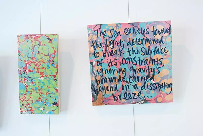 Kerri Shadid, Skirvin Hilton's Artist-in-Residence, creates poems on paintings, shown on the wall of her Skirvin studio. mh