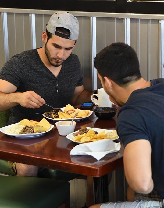 Two guys enjoy their lunch at Maya Latin Cuisine recently.  mh