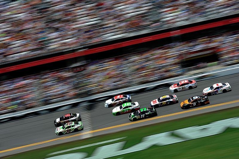 Kyle Busch, driver of the no. 18 Interstate Batteries Toyota, and Dale Earnhardt Jr., driver of the no. 88 National Guard Chevrolet, lead a group of cars at Daytona International Speedway in July. - JARED C. TILTON/NASCAR VIA GETTY IMAGES